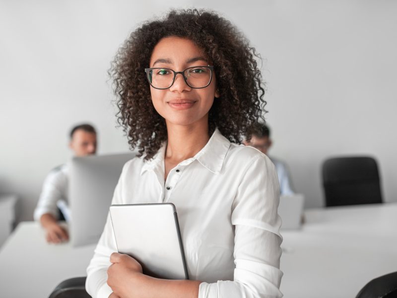 smiling-ethnic-female-recruiter-with-tablet-looking-at-camera-in-office.jpg